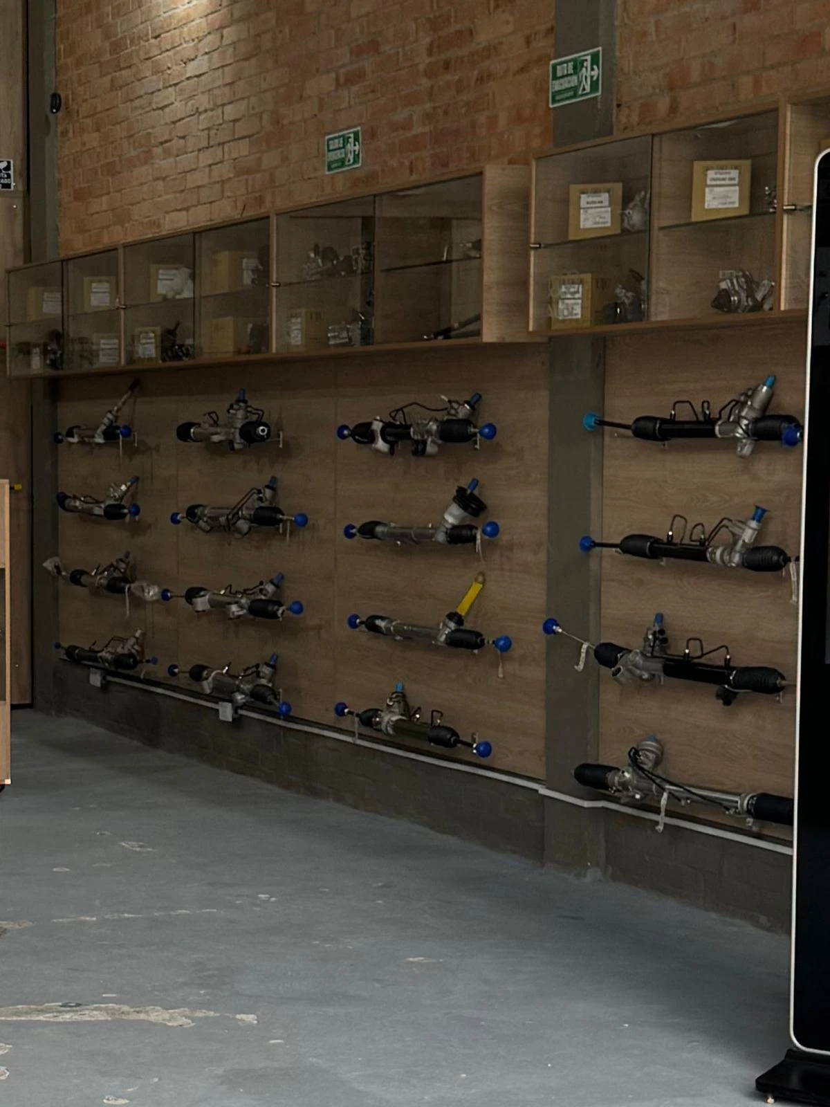 Rows of steering racks on display on a parts wall
